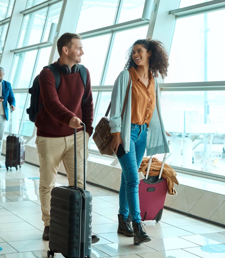 Travel, love and smile with interracial couple in airport for vacation, tourism and departure. Inte.